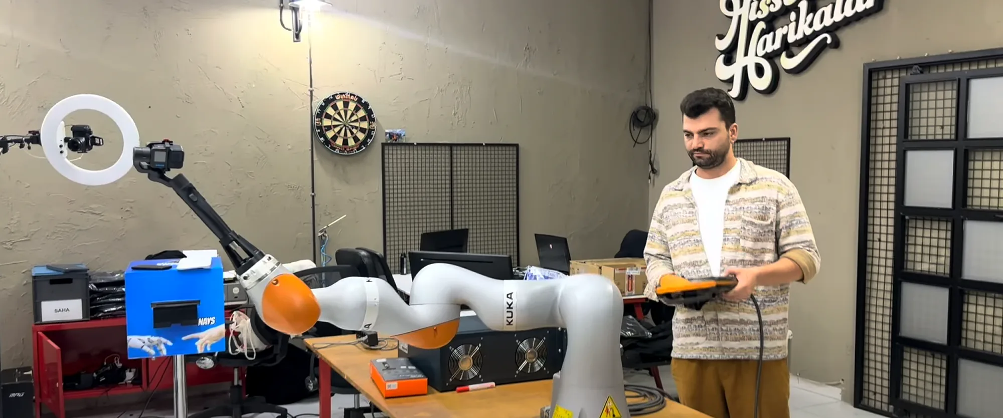 Activation King engineer programming a KUKA robot arm in the workshop