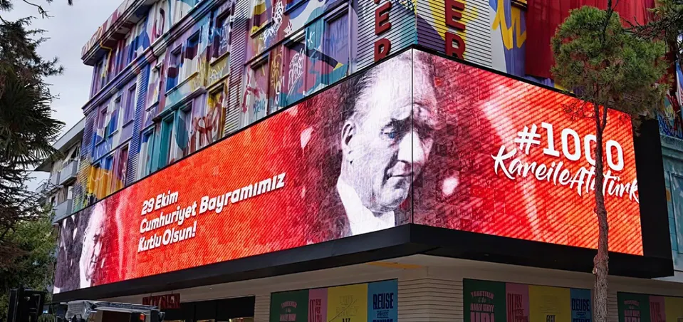 A live photo mosaic on a giant LED screen at an event